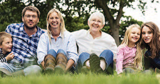 Three generation of a family outdoors posing for a picture.